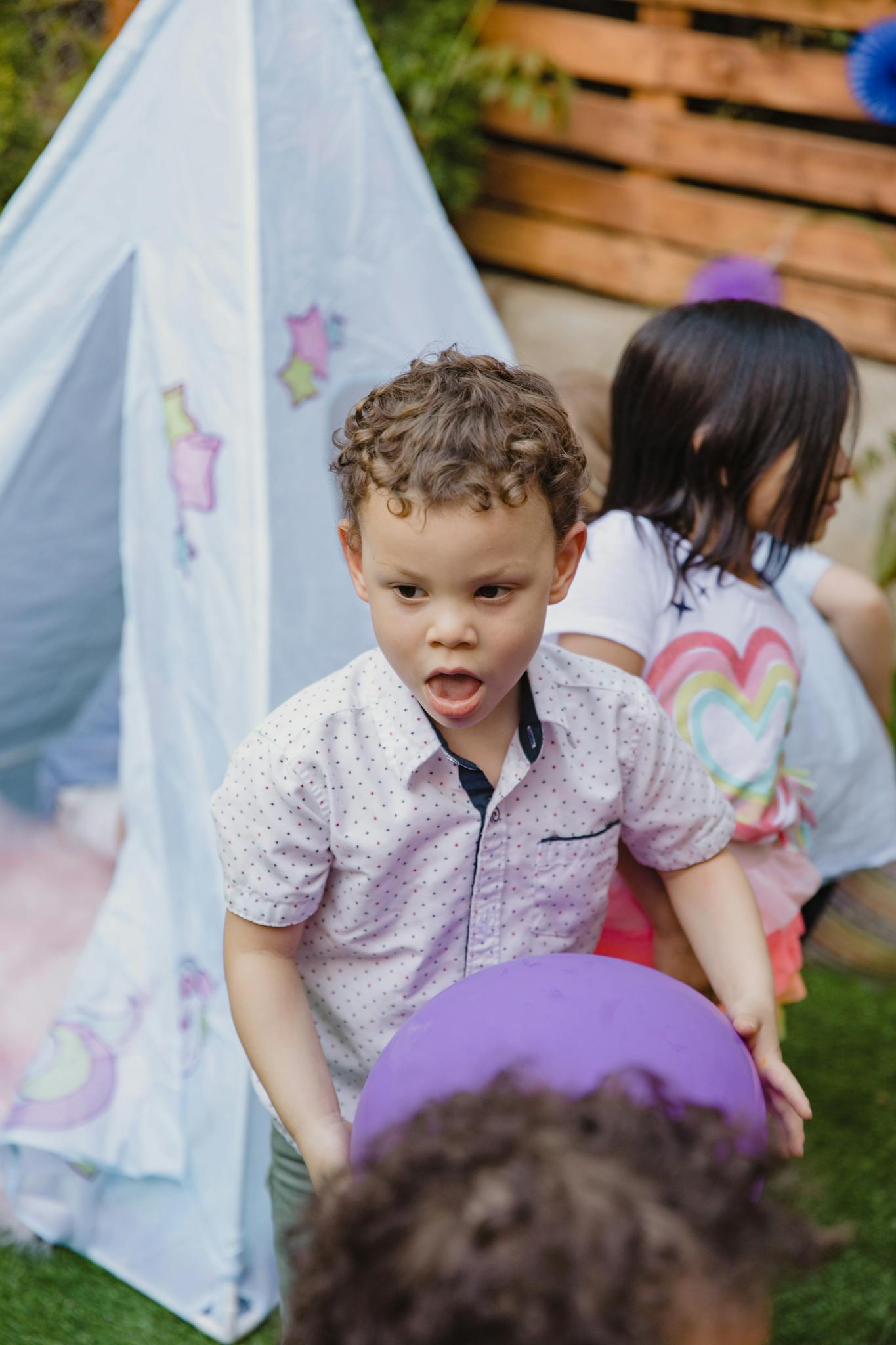 Children enjoying an outdoor birthday party with colorful decorations and playful activities.
